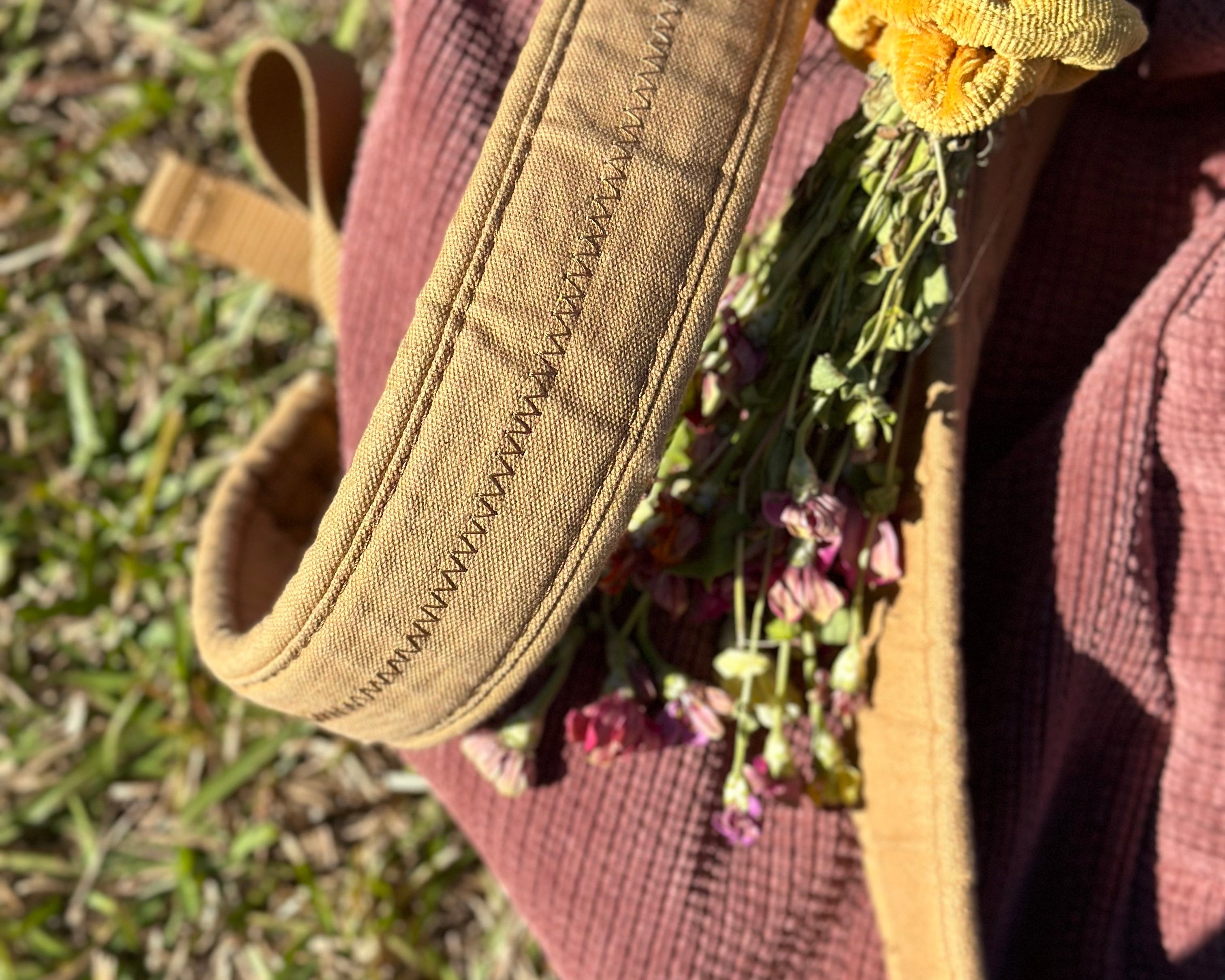 Maroon backpack with fresh flowers attached